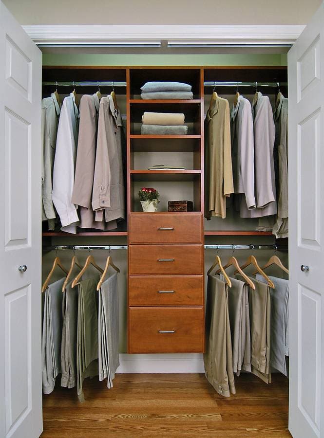 Walk-in closet with brown shelves and cabinets